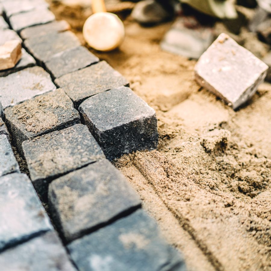 Close up details of roadworks. Stonework on footpath at construction site