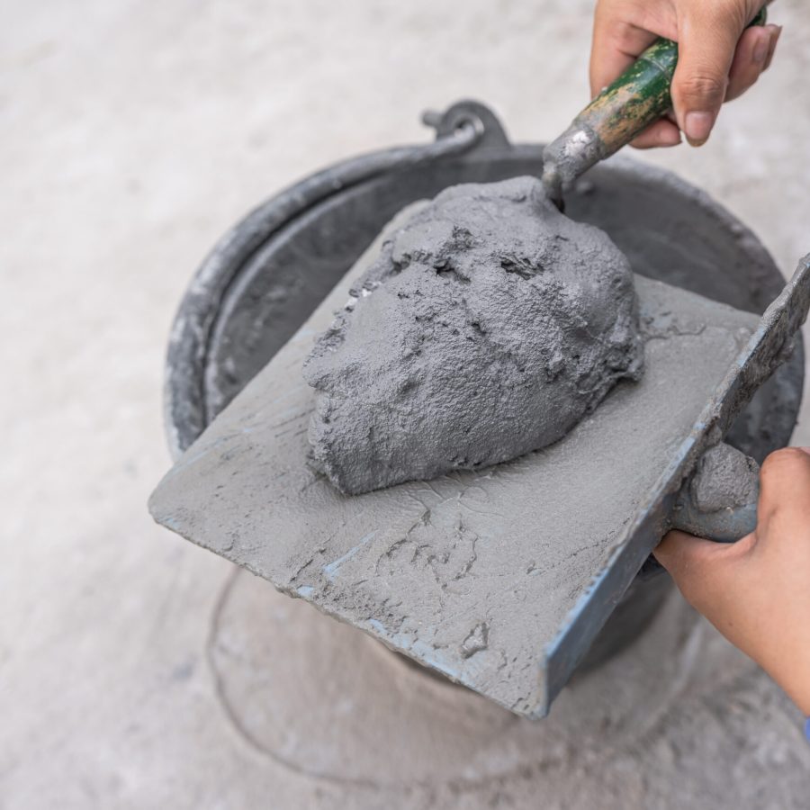 hand-worker-with-trowel-wet-cement-bucket-for-maso-2024-01-24-20-53-57-utc