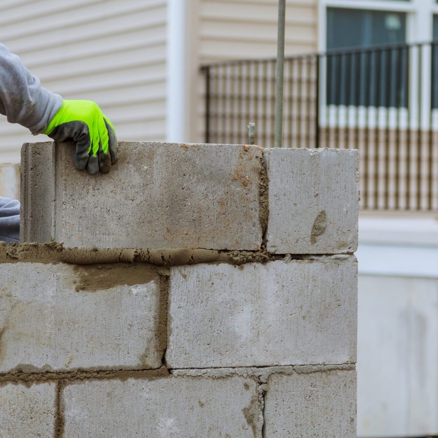 Plaster at construction masonry worker make concrete wall by cement block